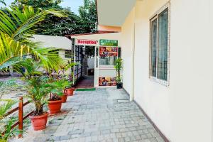 a walkway leading to a store with plants in front at FabHotel Royal Garuda Palace in Bangalore