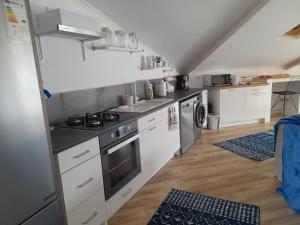 a kitchen with white cabinets and a stove at Turkish Mountain Retreat in Saadet