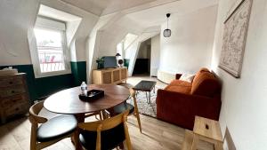 a living room with a table and a couch at Appartement Centre ville Le blanc in Le Blanc
