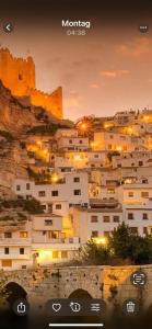 a view of a city with buildings on a mountain at Casa Villar in Alcalá del Júcar