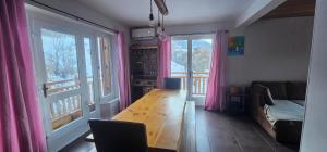 a living room with a couch and a wooden table at La BREZOUNIÉRE 2 in Risoul