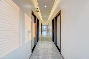 a corridor of a building with doors and a hallway at FabHotel Chhappan in Aurangabad