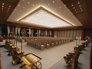 a large banquet hall with chairs and a large ceiling at Euphoria The Fine Dine in Surat