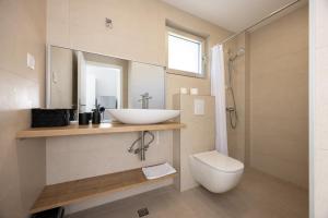 a bathroom with a sink and a toilet at Apartments Klaricic in Živogošće +200 photos
