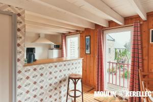 a kitchen with a counter and a window at Gîte Sieck Moulin de Kerellec in Plougoulm