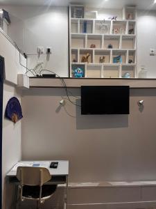 a room with a desk and a tv on a wall at Appart VH - Bienvenue au Lilas in Les Lilas