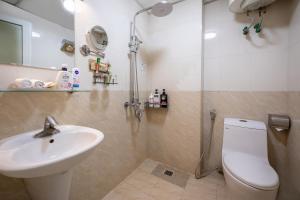 a bathroom with a toilet and a sink and a shower at A25 Hotel - 46 Châu Long in Hanoi +17 photos
