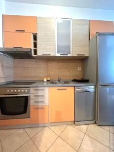 a kitchen with stainless steel appliances and cabinets at Cozy City Studio in Podgorica, Blok 9 in Podgorica
