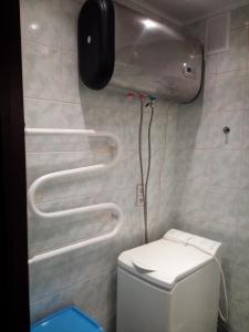 a bathroom with a toilet and a phone on the wall at Апартаменты на пр Александра Невского, 43 in Petrozavodsk