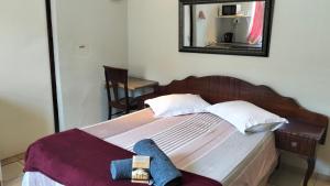 a bedroom with a bed with a mirror on the wall at Overnight Lodge in Cape Town +2 photos