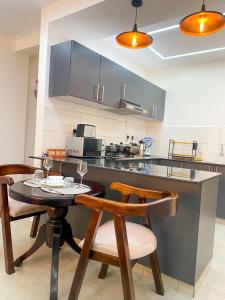 a kitchen with a table and chairs and a counter at Nitro Homes Nyali-Coral Sands in Mombasa