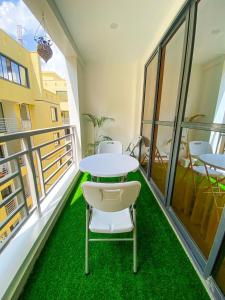a room with a table and chairs on a balcony at Nitro Homes Nyali-Coral Sands in Mombasa