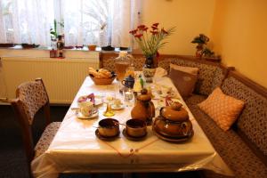 a table with teapots and tea pots on it at Penzion Valovi in Merklín