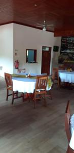 a dining room with two tables and chairs at EcoResorTamarino in M. Peixe