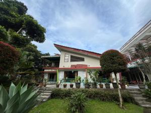 a house with some plants in front of it at Resort Botoel at Puncak in Tagalbato