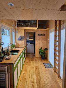 a kitchen with wooden flooring and a counter top at Tiny House Reichle in Boms