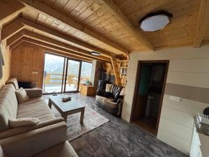 a living room with a couch and a table at Villat Loni in Peje