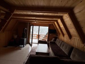 a living room with a couch and a table at Villat Loni in Peje