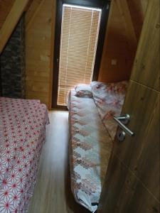 a room with two beds and a door with a window at Villat Loni in Peje