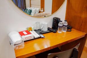 a wooden table with a mirror on top of it at The Elegance Hotel & Suites in Chittagong