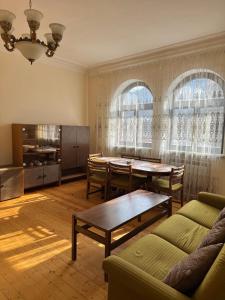 a living room with a table and a couch at RedRose guest house Dilijan in Dilijan