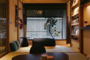 a living room with a large window and a couch at 弎秋 A chu in Chiayi City +6 photos