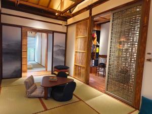 a living room with a table and chairs in a room at 弎秋 A chu in Chiayi City