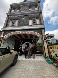 a group of people standing in front of a building at Cio Adventure Hotel in Berastagi