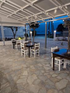 a group of tables and chairs in a patio at To Kyma in Amarynthos