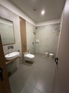 a bathroom with a sink and a toilet and a mirror at Euphoria The Fine Dine in Surat +28 photos