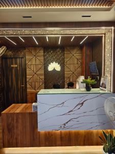 a lobby with a counter in a room at Mohar Residency Madhyamgram in kolkata