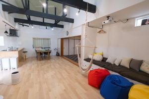 a living room with a couch and a hammock at 里山ハウス in Kamogawa
