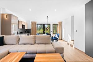 a living room with a couch and a table at Apartmány La Torretta in Harrachov