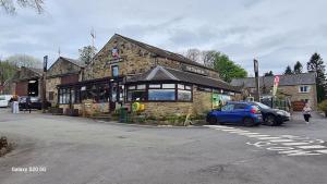 a blue car parked in front of a building at Meadows nook in Clitheroe