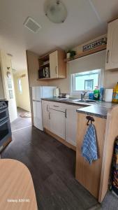 a kitchen with white cabinets and a counter top at Meadows nook in Clitheroe +7 photos