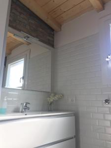 a bathroom with a sink and a mirror at Casa Andrean PT Lido Venezia in Venice-Lido