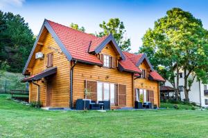 a log cabin with a red roof at Planinske kuce Good Night in Donji Babin Potok