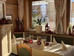 a table with christmas decorations on it in a room at Hotel Neuwirt in Brandenberg
