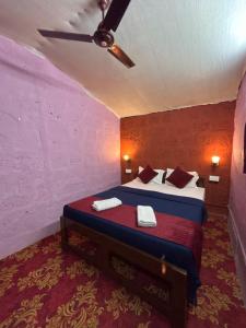 a bedroom with a bed and a ceiling fan at Prakriti Resort in Arambol +50 photos