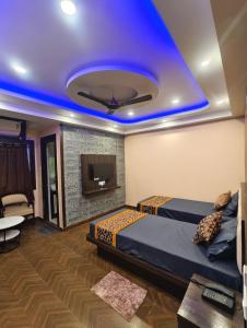 a room with a bed and a blue ceiling at Mohar Residency Madhyamgram in kolkata