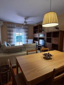 a living room with a table and a couch at La Casa del Camaleon in Chipiona +6 photos