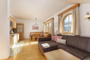 a living room with a couch and a table at Kainreiterhof in Aich