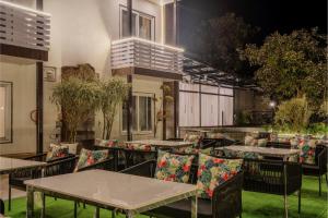 a group of tables and chairs on a patio at Sunoraa Luxury Hotel & Spa in Mussoorie