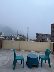 two chairs and a table on top of a roof at Bunk House in Rishīkesh