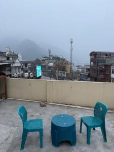 two chairs and a table on top of a roof at Bunk House in Rishīkesh