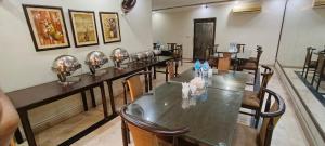 a row of tables with helmets on them in a room at Herfa INN Hotel Lahore in Lahore +38 photos