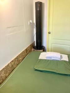 a room with a bed next to a heater at 326 Podtel at The Breakie Bar in Bangkok