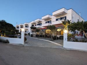 a large white building with lights in front of it at To Kyma in Amarynthos