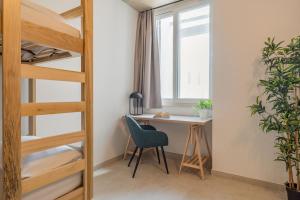 a bedroom with a desk and a bunk bed at 224 Boutique Hostel in Sliema