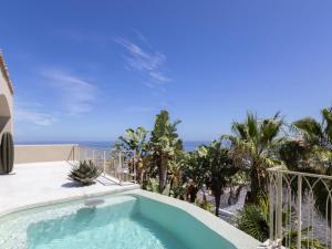 a swimming pool with a view of the ocean at Luxury 8-Suite Villa with Heated Pools, Ocean & Mountain Views in Cape Town